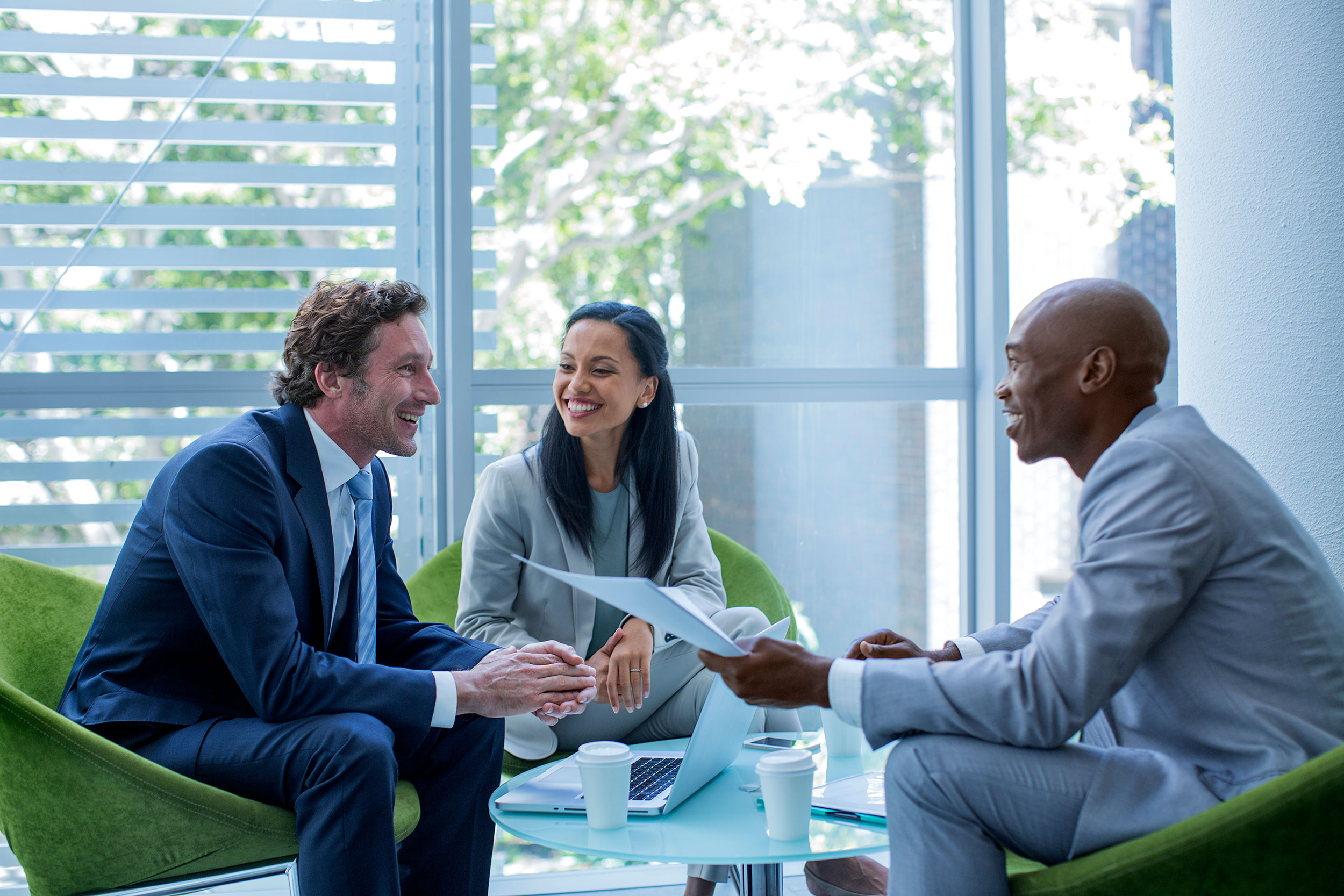 Seated business people have an upbeat discussion.